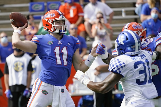 Florida quarterback Kyle Trask (11) throws a pass as Kentucky linebacker Jamar Watson (31) rushes during the first half of an NCAA college football game, Saturday, Nov. 28, 2020, in Gainesville, Fla. (AP Photo/John Raoux)