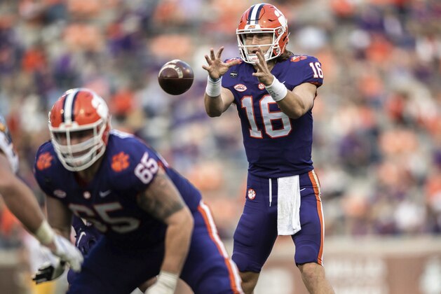 Clemson quarterback Trevor Lawrence (16) takes a snap during the first half of an NCAA college football game   against Pittsburgh Saturday, Nov. 28, 2020, in Clemson, S.C. (Ken Ruinard/The Independent-Mail via AP, Pool)