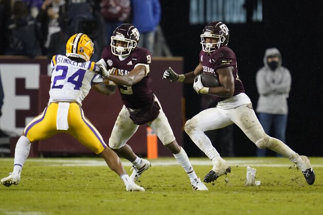 Texas A&M running back Isaiah Spiller (28) follows the block by wide receiver Hezekiah Jones (9) on LSU cornerback Derek Stingley Jr. (24) during the third quarter of an NCAA college football game Saturday, Nov. 28, 2020. in College Station, Texas. (AP Photo/Sam Craft)