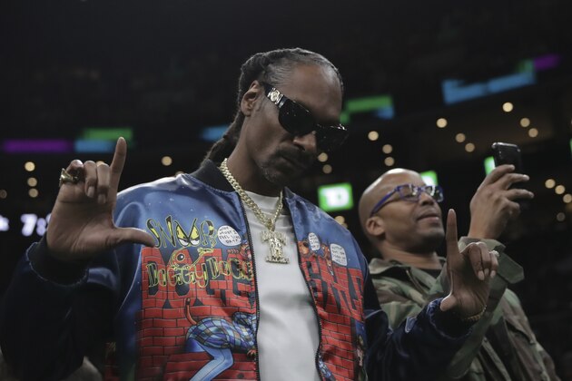 Rapper Snoop Dogg prior to the first half of an NBA basketball game in Boston, Monday, Jan. 20, 2020. (AP Photo/Charles Krupa)