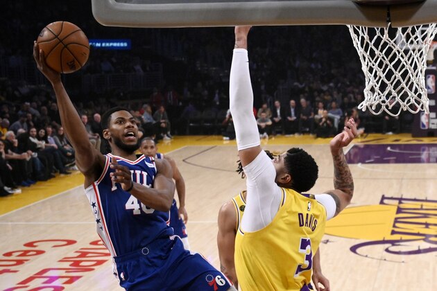 Philadelphia 76ers forward Glenn Robinson III, left, shoots as Los Angeles Lakers forward Anthony Davis defends during the first half of an NBA basketball game Tuesday, March 3, 2020, in Los Angeles. (AP Photo/Mark J. Terrill)