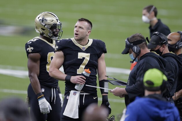New Orleans Saints quarterback Taysom Hill (7) talks to head coach Sean Payton during a timeout in the first half of an NFL football game against the Atlanta Falcons in New Orleans, Sunday, Nov. 22, 2020. (AP Photo/Brett Duke)