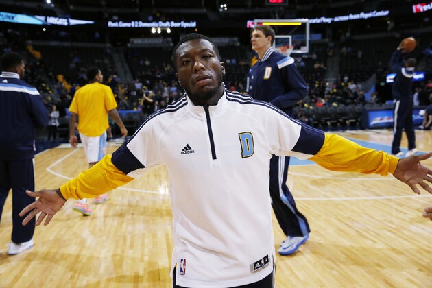 Denver Nuggets guard Nate Robinson jokes with photographer while warming up to face the  Oklahoma City Thunder in the first quarter of an NBA basketball game in Denver on Wednesday, Nov. 19, 2014. (AP Photo/David Zalubowski)