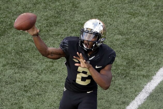 Wake Forest's Kendall Hinton (2) throws a pass under pressure from Clemson's Xavier Thomas (3) during the second half of an NCAA college football game in Charlotte, N.C., Saturday, Oct. 6, 2018. (AP Photo/Chuck Burton)