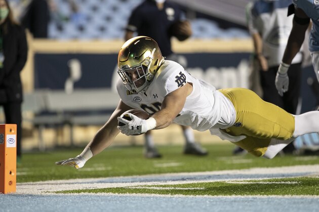 Notre Dame's George Takacs (85) gets past North Carolina's Tyrone Hopper (42) picking up 13 yards on a pass completion from quarterback Ian Book (12) and dive toward the goal line, but is stopped short during the fourth quarter of an NCAA college football game Friday, Nov. 27, 2020, in Chapel Hill, N.C. (Robert Willett/The News & Observer via AP, Pool)
