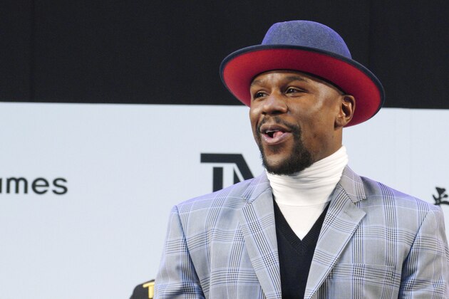 Floyd Mayweather Jr. smiles at the stage as he meets Japanese kickboxer Tenshin Nasukawa, during a ceremony at Saitama Super Arena in Saitama, north of Tokyo Sunday, Dec. 30, 2018. Mayweather is scheduled to fight in a three-round exhibition match in Japan on New Year's Eve. (AP Photo/Eugene Hoshiko)