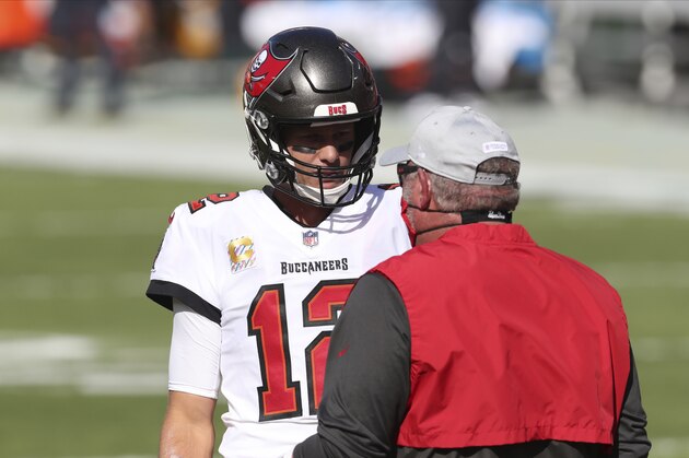 Tampa Bay Buccaneers quarterback Tom Brady (12) talks to head coach Bruce Arians before an NFL football game against the Green Bay Packers Sunday, Oct. 18, 2020, in Tampa, Fla. (AP Photo/Mark LoMoglio)