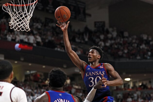 Kansas' Ochai Agbaji (30) lays up the ball during the second half of an NCAA college basketball game against Texas Tech, Saturday, March 7, 2020, in Lubbock, Texas. (AP Photo/Brad Tollefson)