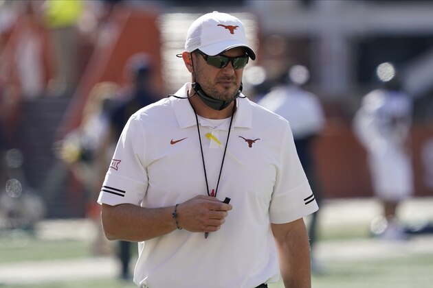 Texas head coach Tom Herman watches his team warm up before an NCAA college football game against West Virginia in Austin, Texas, Saturday, Nov. 7, 2020. (AP Photo/Chuck Burton)
