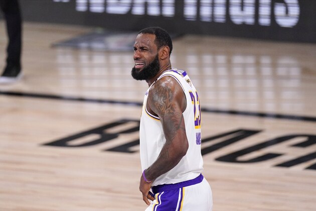 Los Angeles Lakers' LeBron James (23) reacts after colliding with Miami Heat's Goran Dragic (7) during the first half in Game 6 of basketball's NBA Finals Sunday, Oct. 11, 2020, in Lake Buena Vista, Fla. (AP Photo/Mark J. Terrill)