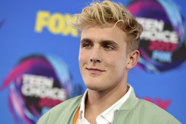 FILE - Internet personality Jake Paul arrives at the Teen Choice Awards in Los Angeles on Aug. 13, 2017. FBI agents including a SWAT team have raided the apparent home of YouTube star Jake Paul. FBI spokeswoman Laura Eimiller says agents executed a search warrant Wednesday at the Calabasas, California mansion in connection with an ongoing investigation. She could not say what the probe is about or who the target was. Helicopter video from local TV news showed agents gathering guns from the home that can frequently be seen on Paul's YouTube channel, which has over 20 million followers. (Photo by Jordan Strauss/Invision/AP, File)