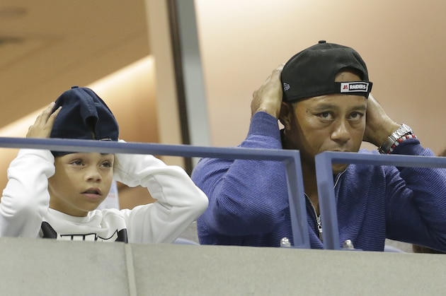 ADDS THE NAME OF TIGER WOODS SON, CHARLIE - Golfer Tiger Woods watches a match between Rafael Nadal, of Spain, and Marin Cilic, of Croatia, with his son, Charlie, during the fourth round of the U.S. Open tennis tournament, Monday, Sept. 2, 2019, in New York. (AP Photo/Seth Wenig)
