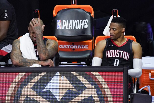 Houston Rockets' P.J. Tucker, left, and Russell Westbrook sit on the bench in the closing minutes of a loss to the Los Angeles Lakers during the second half of an NBA conference semifinal playoff basketball game Saturday, Sept. 12, 2020, in Lake Buena Vista, Fla. (AP Photo/Mark J. Terrill)