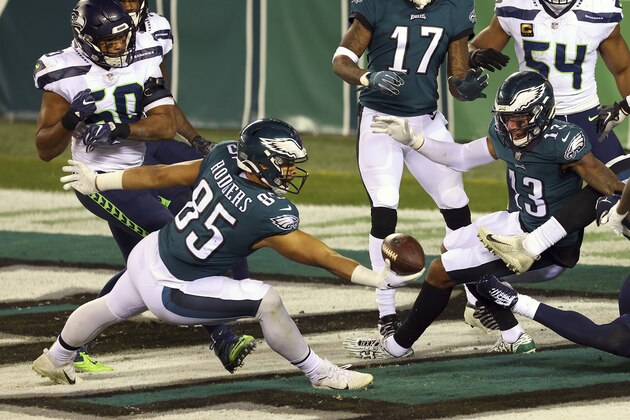 Philadelphia Eagles' Richard Rodgers (85) makes a one handed catch for a 33 yard touchdown on a ball tipped by teammate Travis Fulgham (13) with 12 seconds remaining as Seattle Seahawks' Jamal Adams (33) defends in an NFL football game, Monday, Nov. 30, 2020, in Philadelphia. The Seahawks defeated the Eagles (AP Photo/Rich Schultz)
