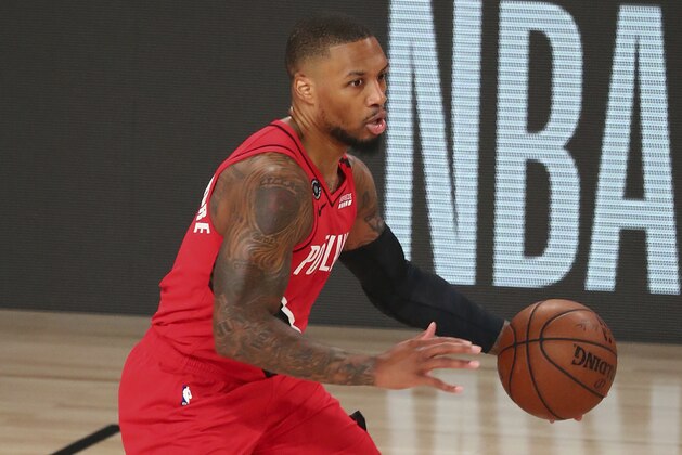 Portland Trail Blazers guard Damian Lillard (0) brings the ball upcourt against the Los Angeles Lakers during the first half of Game 2 of an NBA basketball first-round playoff series, Thursday, Aug. 20, 2020, in Lake Buena Vista, Fla. (Kim Klement/Pool Photo via AP)
