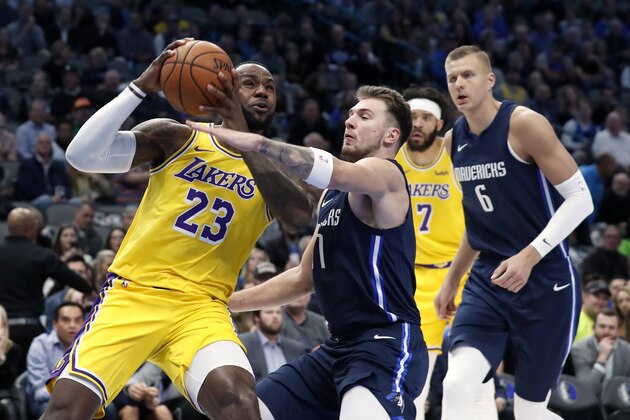 Los Angeles Lakers forward LeBron James (23) drives to the basket as Dallas Mavericks' Luka Doncic (77) and Kristaps Porzingis (6) defend during the first half of an NBA basketball game in Dallas, Friday, Nov. 1, 2019. (AP Photo/Tony Gutierrez) Los Angeles Lakers forward LeBron James (23) drives to the basket as Dallas Mavericks' Luka Doncic (77) and Kristaps Porzingis (6) defend during the first half of an NBA basketball game in Dallas, Friday, Nov. 1, 2019. (AP Photo/Tony Gutierrez)