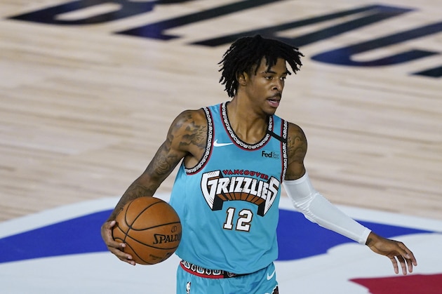 Memphis Grizzlies' Ja Morant (12) makes his way down the court during an NBA basketball game against the New Orleans Pelicans Monday, Aug. 3, 2020, in Lake Buena Vista, Fla. (AP Photo/Ashley Landis, Pool)
