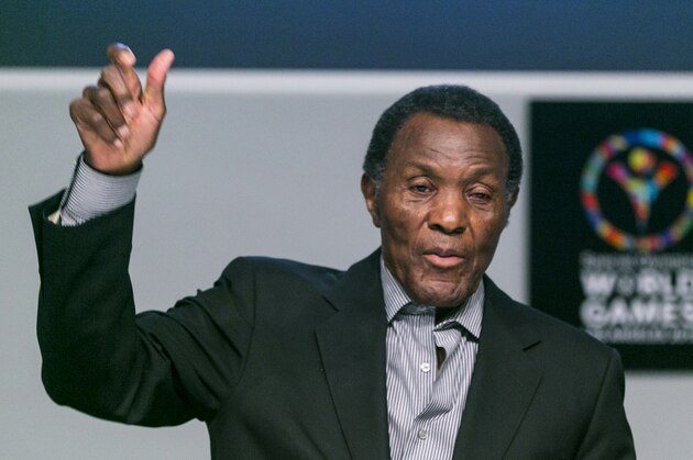 FILE - In this July 20, 2015, file photo, Olympic gold medalist and philanthropist Rafer Johnson lifts his arm to mimic the lighting of the Olympic torch as he recalls the first Special Olympics World Games he attended, during a news conference in Los Angeles. Rafer Johnson, who won the decathlon at the 1960 Rome Olympics and helped subdue Robert F. Kennedy's assassin in 1968, died Wednesday, Dec. 2, 2020. He was 86. He died at his home in the Sherman Oaks section of Los Angeles, according to family friend Michael Roth.(AP Photo/Damian Dovarganes)