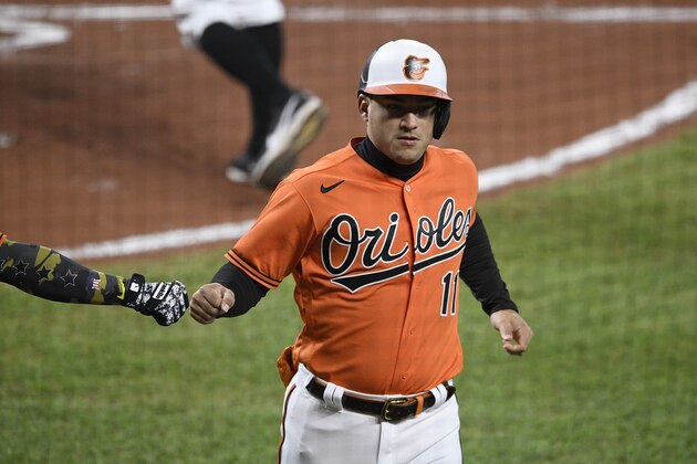Baltimore Orioles' Jose Iglesias (11) gets a fist bump after he scored during a baseball game against the Tampa Bay Rays, Saturday, Sept. 19, 2020, in Baltimore. (AP Photo/Nick Wass)