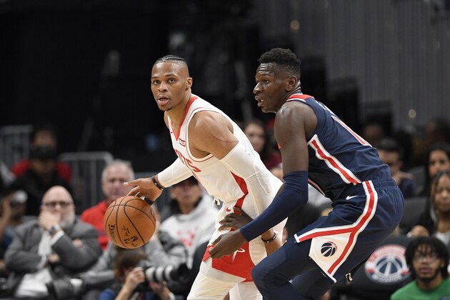 Houston Rockets guard Russell Westbrook (0) dribbles the ball against Washington Wizards guard Isaac Bonga, right, during the second half of an NBA basketball game, Wednesday, Oct. 30, 2019, in Washington. The Rockets won 159-158. (AP Photo/Nick Wass)