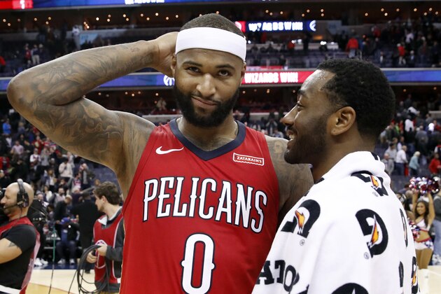 New Orleans Pelicans center DeMarcus Cousins, left, reacts as he talks with Washington Wizards guard John Wall after an NBA basketball game Tuesday, Dec. 19, 2017, in Washington. The Wizards won 116-106. (AP Photo/Alex Brandon)