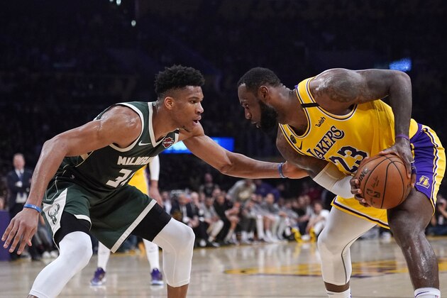 Los Angeles Lakers forward LeBron James, tries to get past Milwaukee Bucks forward Giannis Antetokounmpo during the second half of an NBA basketball game Friday, March 6, 2020, in Los Angeles. (AP Photo/Mark J. Terrill)