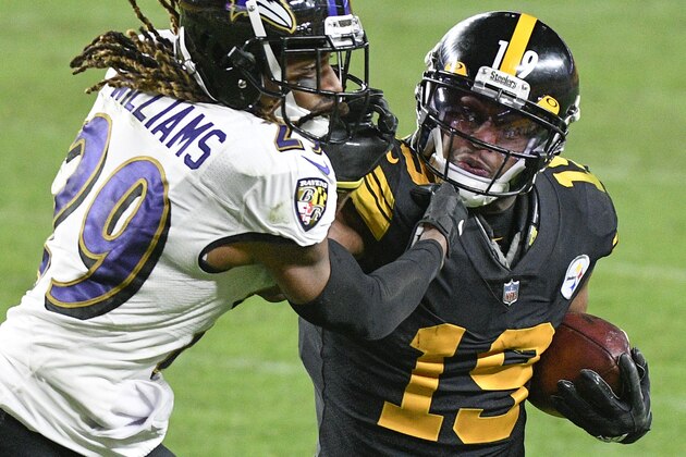 Pittsburgh Steelers wide receiver JuJu Smith-Schuster (19) tries to fend off Baltimore Ravens cornerback Tramon Williams after making a catch during the second half of an NFL football game Wednesday, Dec. 2, 2020, in Pittsburgh. (AP Photo/Don Wright)
