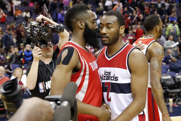 Houston Rockets guard James Harden, center left, and Washington Wizards guard John Wall (2) talk after an NBA basketball game Sunday, March 29, 2015, in Washington. The Rockets won 99-91. (AP Photo/Alex Brandon)