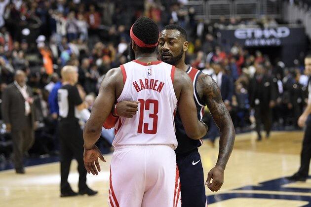 Washington Wizards guard John Wall, right, meets with Houston Rockets guard James Harden (13) after an NBA basketball game, Monday, Nov. 26, 2018, in Washington. The Wizards won 135-131. (AP Photo/Nick Wass)