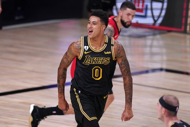 Los Angeles Lakers' Kyle Kuzma (0) celebrates a three-point basket scored by Markieff Morris during the first half of an NBA conference semifinal playoff basketball game against the Houston Rockets Sunday, Sept. 6, 2020, in Lake Buena Vista, Fla. (AP Photo/Mark J. Terrill)