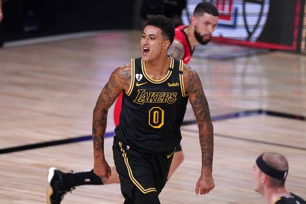 Los Angeles Lakers' Kyle Kuzma (0) celebrates a three-point basket scored by Markieff Morris during the first half of an NBA conference semifinal playoff basketball game against the Houston Rockets Sunday, Sept. 6, 2020, in Lake Buena Vista, Fla. (AP Photo/Mark J. Terrill)