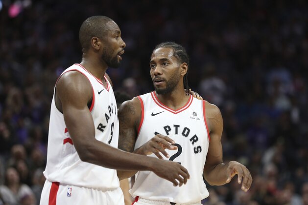 Toronto Raptors forward Serge Ibaka, left, talks with teammate Kawhi Leonard during the second half of an NBA basketball game against the Sacramento Kings, Wednesday, Nov. 7, 2018, in Sacramento, Calif. The Raptors won 114-105. (AP Photo/Rich Pedroncelli)