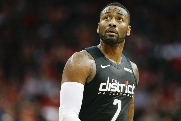 FILE - In this Dec. 19, 2018 file photo, Washington Wizards guard John Wall walks off the court during a timeout during the second half of an NBA basketball game against the Houston Rockets in Houston.  The Wizards general manager Tommy Sheppard says on Monday, Nov. 23, 2020, he has no plans to trade John Wall and is looking forward to seeing the point guard reunited in the backcourt with Bradley Beal.(AP Photo/Eric Christian Smith, File)