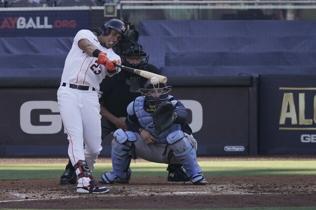 Houston Astros' Michael Brantley hits a two run RBI single against the Tampa Bay Rays during the third inning in Game 5 of a baseball American League Championship Series, Thursday, Oct. 15, 2020, in San Diego. (AP Photo/Jae C. Hong)