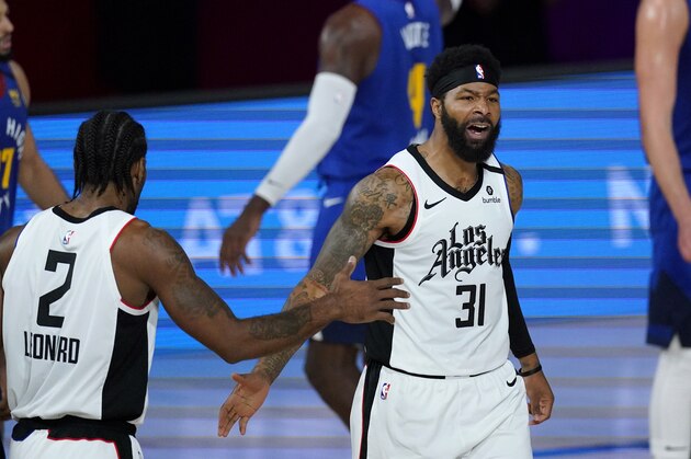 Los Angeles Clippers' Marcus Morris Sr. (31) and Kawhi Leonard (2) celebrate during the first half of an NBA conference semifinal playoff basketball game, Friday, Sept. 11, 2020, in Lake Buena Vista, Fla. (AP Photo/Mark J. Terrill)