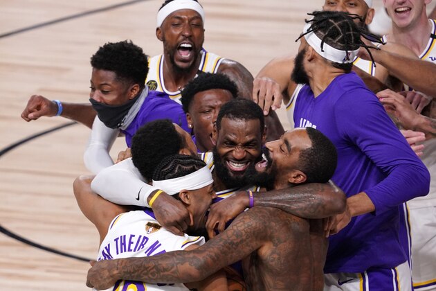 Los Angeles Lakers' LeBron James (23) celebrates with his teammates after the Lakers defeated the Miami Heat 106-93 in Game 6 of basketball's NBA Finals Sunday, Oct. 11, 2020, in Lake Buena Vista, Fla. (AP Photo/Mark J. Terrill)