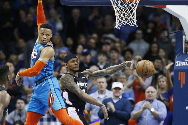 Washington Wizards guard Bradley Beal, right, passes behind Oklahoma City Thunder guard Russell Westbrook, left, in the second half of an NBA basketball game in Oklahoma City, Sunday, Jan. 6, 2019. (AP Photo/Sue Ogrocki)