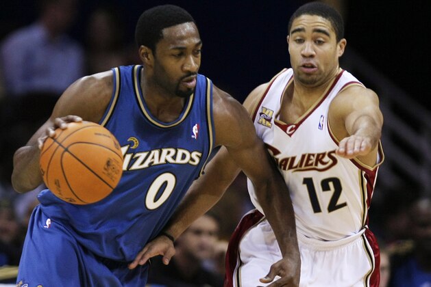 Washington Wizards' Gilbert Arenas (0) drives around Cleveland Cavaliers' Andre Barrett (12) in the first quarter of a preseason NBA basketball game Wednesday, Oct. 14, 2009, in Cleveland.  (AP Photo/Mark Duncan)