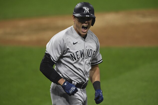 New York Yankees' Gio Urshela celebrates while running the bases after hitting a grand slam off Cleveland Indians relief pitcher James Karinchak in the fourth inning of Game 2 of an American League wild-card baseball series, Wednesday, Sept. 30, 2020, in Cleveland. (AP Photo/David Dermer)