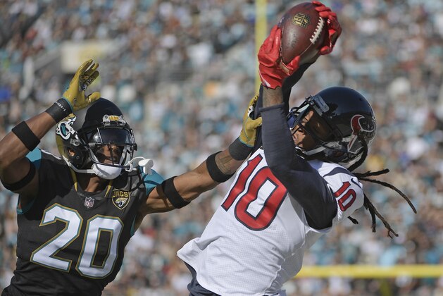 Houston Texans wide receiver DeAndre Hopkins (10) makes a reception over Jacksonville Jaguars cornerback Jalen Ramsey (20) during the first half of an NFL football game, Sunday, Dec. 17, 2017, in Jacksonville, Fla. (AP Photo/Phelan M. Ebenhack)
