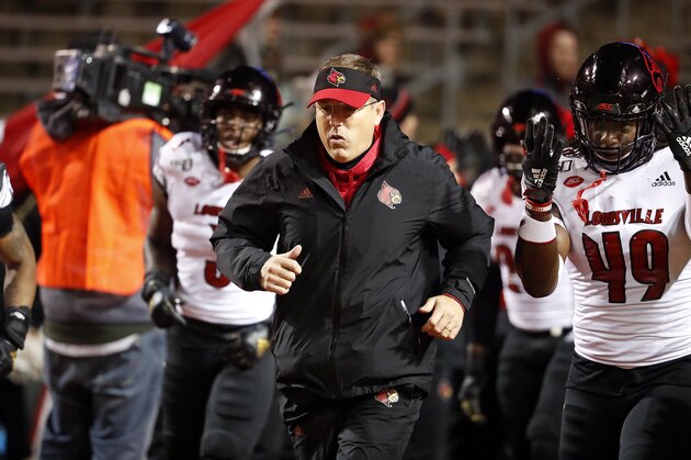 Louisville head coach Scott Satterfield runs onto the field prior to the start of an NCAA college football game against North Carolina State in Raleigh, N.C., Saturday, Nov. 16, 2019. (AP Photo/Karl B DeBlaker)