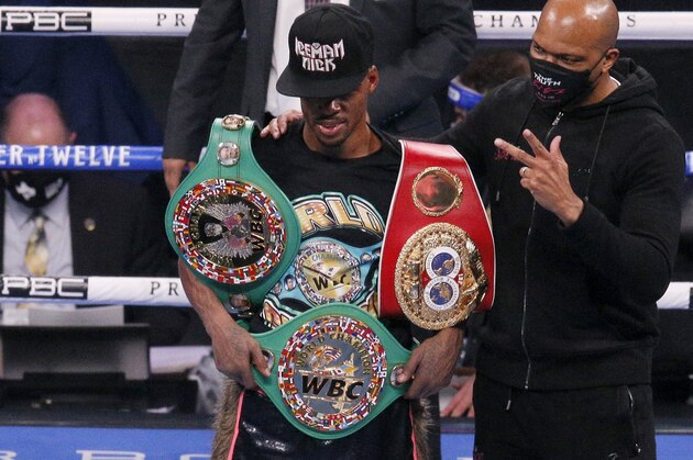 Errol Spence Jr., poses by trainer Derrick James after defeating Danny Garcia for the WBC IBF welterweight championships in a boxing bout in Arlington, Texas, Saturday, Dec. 5, 2020. (AP Photo/Brandon Wade) Errol Spence Jr., poses by trainer Derrick James after defeating Danny Garcia for the WBC IBF welterweight championships in a boxing bout in Arlington, Texas, Saturday, Dec. 5, 2020. (AP Photo/Brandon Wade)