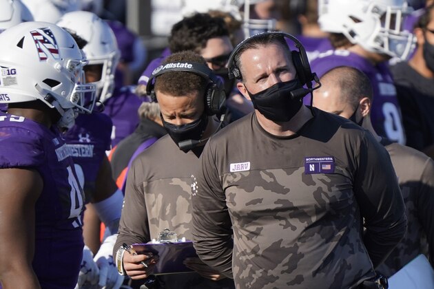 FILE - In this Saturday, Nov. 7, 2020, file photo, Northwestern head coach Pat Fitzgerald looks at the scoreboard during the second half of an NCAA college football game against Nebraska in Evanston, Ill. In an era when the College Football Playoff increasingly features the nation’s highest-scoring teams, this year’s Big Ten race shows defense still matters. That’s just the way Northwestern coach and former All-America linebacker Pat Fitzgerald likes it. (AP Photo/Nam Y. Huh, File)