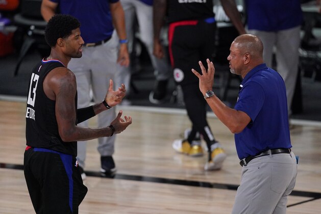 Los Angeles Clippers head coach Doc Rivers, right, talks with Paul George (13) during the second half of an NBA conference semifinal playoff basketball game against the Denver Nuggets Saturday, Sept. 5, 2020, in Lake Buena Vista, Fla. (AP Photo/Mark J. Terrill)