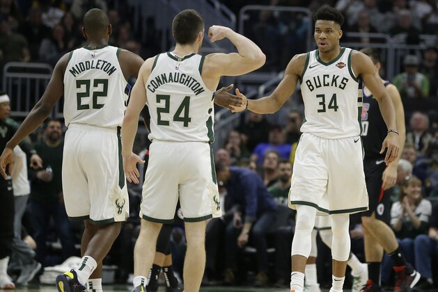 Milwaukee Bucks' Giannis Antetokounmpo (34) celebrates with Pat Connaughton (24) and Khris Middleton (22) during the first half of an NBA basketball game against the Los Angeles Clippers, Thursday, March 28, 2019, in Milwaukee. (AP Photo/Aaron Gash)
