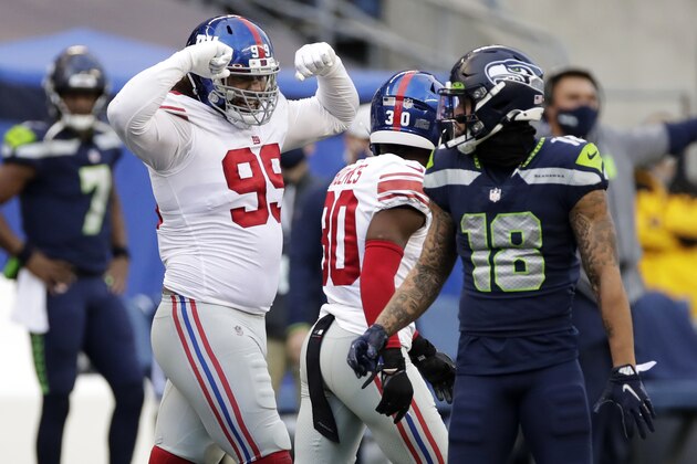 New York Giants defensive end Leonard Williams, left, reacts next to Seattle Seahawks wide receiver Freddie Swain (18) after a play during the second half of an NFL football game, Sunday, Dec. 6, 2020, in Seattle. (AP Photo/Larry Maurer) New York Giants defensive end Leonard Williams, left, reacts next to Seattle Seahawks wide receiver Freddie Swain (18) after a play during the second half of an NFL football game, Sunday, Dec. 6, 2020, in Seattle. (AP Photo/Larry Maurer)
