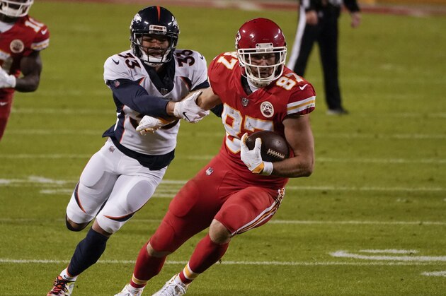 Kansas City Chiefs tight end Travis Kelce (87) is tackled by Denver Broncos safety Alijah Holder (33) in the second half of an NFL football game in Kansas City, Mo., Sunday, Dec. 6, 2020. (AP Photo/Charlie Riedel)