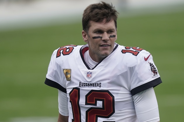 Tampa Bay Buccaneers quarterback Tom Brady (12) warms up before the first half of an NFL football game between the Carolina Panthers and the Tampa Bay Buccaneers, Sunday, Nov. 15, 2020, in Charlotte , N.C. (AP Photo/Gerry Broome)
