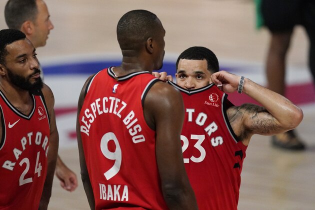 Toronto Raptors' Fred VanVleet (23) talks with teammate Serge Ibaka (9) after Ibaka was called for a technical foul during the second half of an NBA conference semifinal playoff basketball game against the Boston Celtics Monday, Sept. 7, 2020, in Lake Buena Vista, Fla. (AP Photo/Mark J. Terrill)