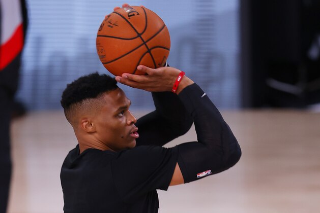 Houston Rockets' Russell Westbrook warms up before an NBA basketball game against the Milwaukee Bucks, Sunday, Aug. 2, 2020, in Lake Buena Vista, Fla. (Mike Ehrmann/Pool Photo via AP)